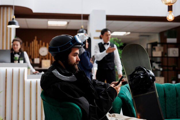 Man engaged with smartphone in lounge