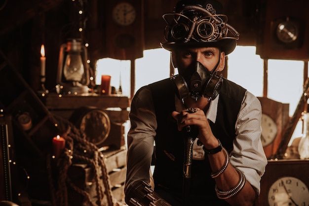 Man of engineers in a steampunk suit with a top hat with glasses and a gas mask