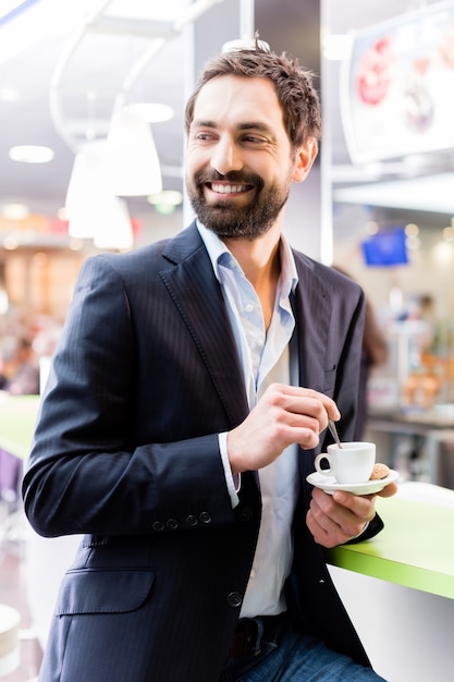 man enjoying espresso in cafe