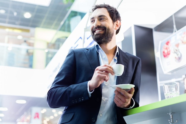 man enjoying espresso in cafe