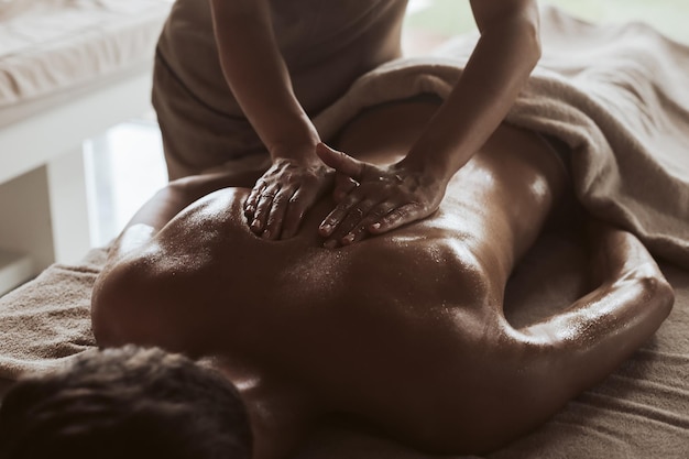 Man enjoying a relaxing back massage in Spa