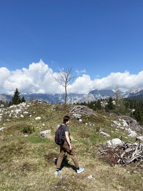 man enjoys views of the alpine village in mountains. Velika Planina. Big Pasture Plateau. Slovenia