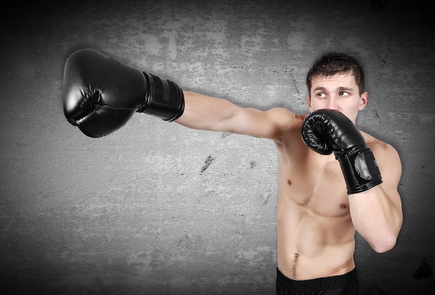 Man exercising boxing in gloves