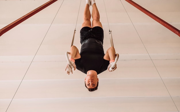 Man exercising on gymnastics rings