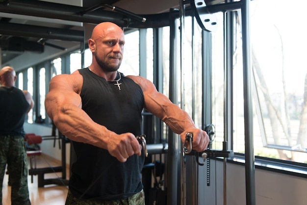 Man Exercising Shoulders In The Gym