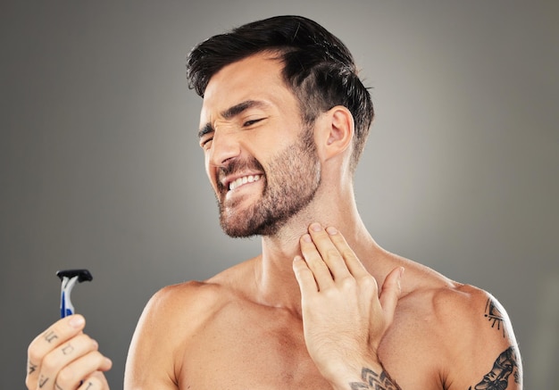 Man face and shaving pain on neck for skincare beauty or cosmetics wellness in studio Facial care hygiene dermatology grooming acciedent and shave beard for skin healthcare against grey background