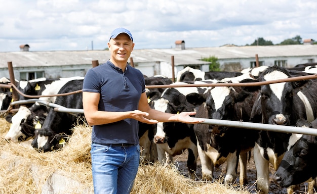 Man farmer on farm with dairy cow