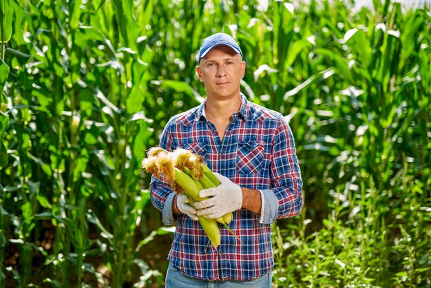 Man farmer with a crop of corn.