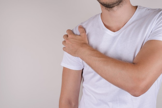 Man feeling pain in shoulder