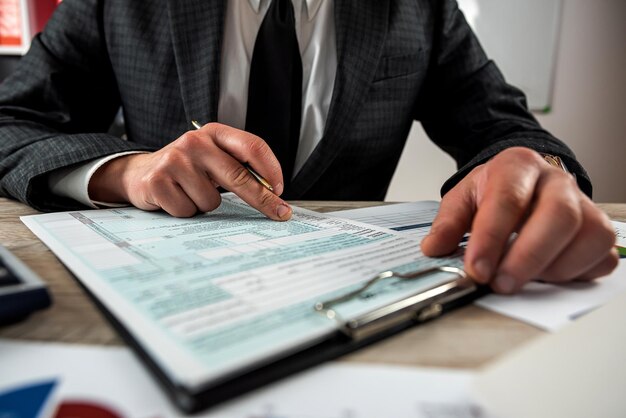 Man filling 1040 blank US tax form at the office