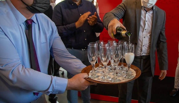 Man filling champagne glass at celebration