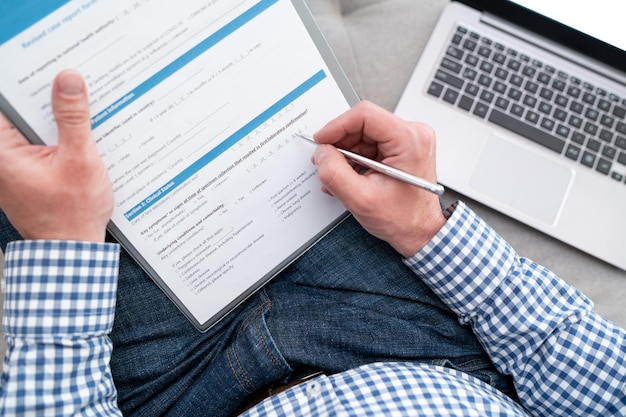 A man fills out a medical form for coronavirus test he is on quarantine