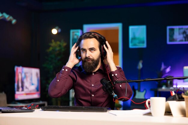 Man filming himself listening to new album from favorite artist reviewing music in studio