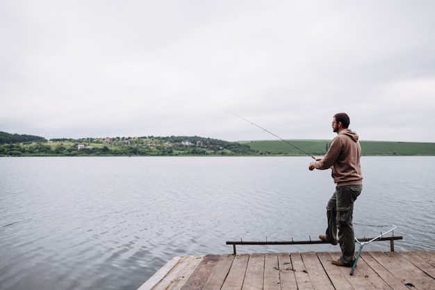 Man fishing in the calm lake