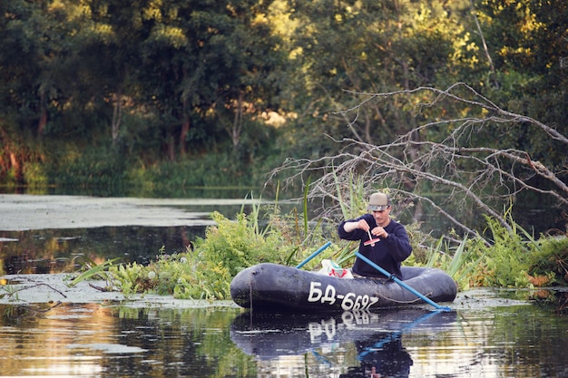 Man fishing for pike on a boat