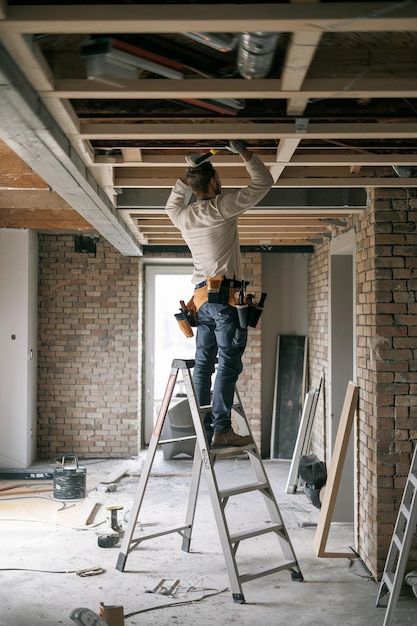 Man fixing ceiling during renovation