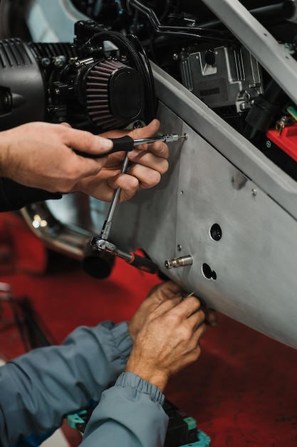 Man fixing a motorcycle in a modern workshop