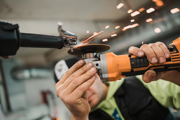 Man fixing a motorcycle in a modern workshop