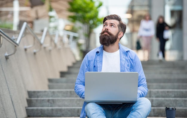 Man freelancer has video call outdoor copy space man freelancer has video call on laptop