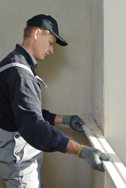 Man gets manually gypsum plaster