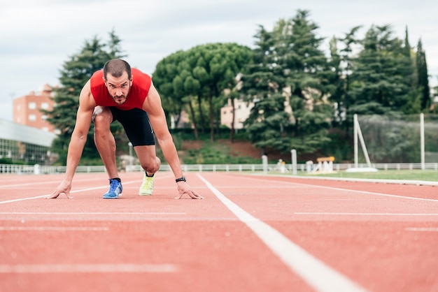 Man getting ready to start running on Stadium