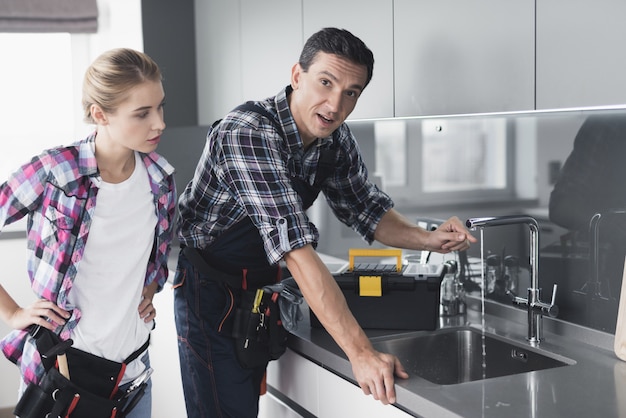 A man and a girl checks the sink for breakage.