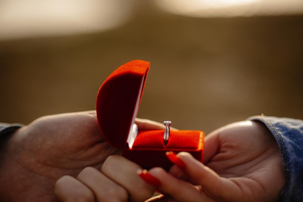 A man gives a ring to a woman.