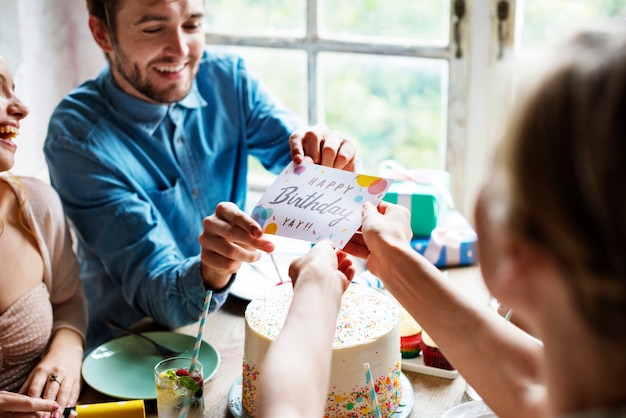 Man Giving Birthday Wishing Card to Friend