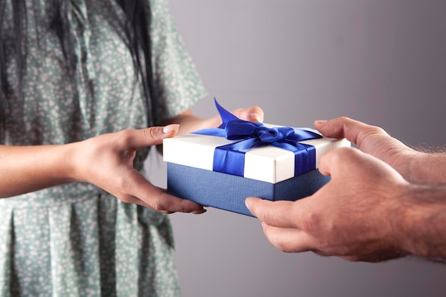 Man giving gift box to his girlfriend close up