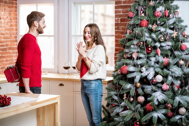 Man giving a new year gift for a woman at home