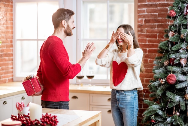 Man giving a new year gift for a woman at home