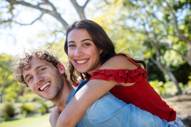 Man giving a piggyback ride to woman