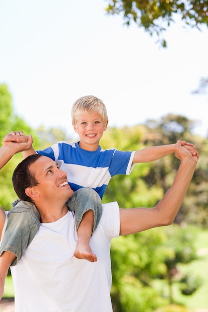 Man giving son a piggyback during the summer 