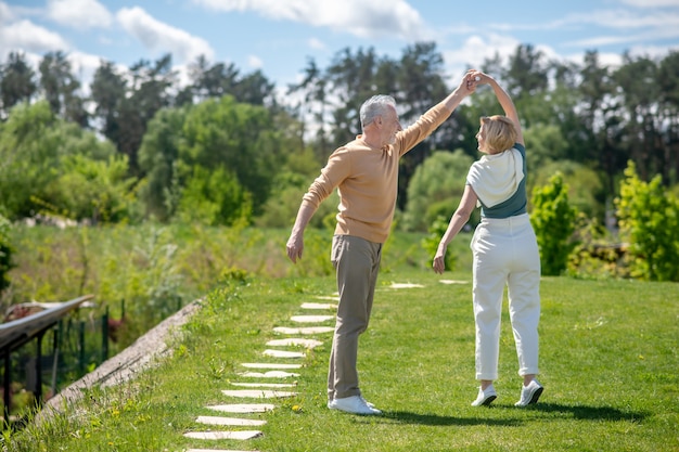 Man giving a woman a dancing lesson