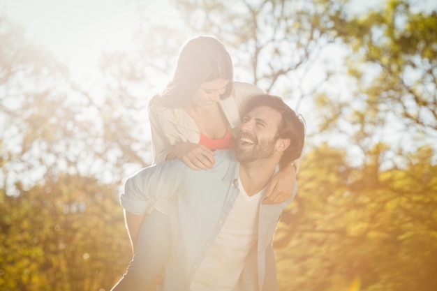 Man giving woman piggyback ride