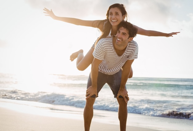 Man giving woman piggyback ride