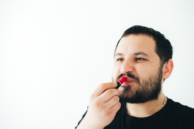 man in glasses with a beard wearing a red lip as a gay