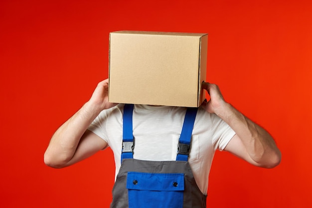 Man got his head stuck in a cardboard box and is trying to take it off