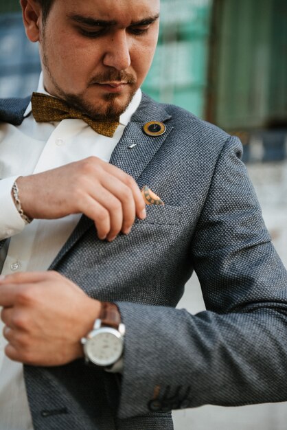 A man in a gray suit poses on the street to advertise men's clothing. Shooting for men's clothing store