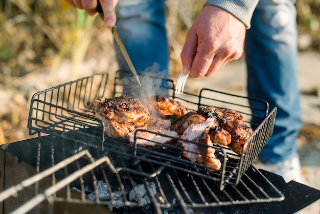 A man grilling steak on a bbq grill