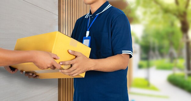 Man hand accepting a delivery service boxes package from delivery man