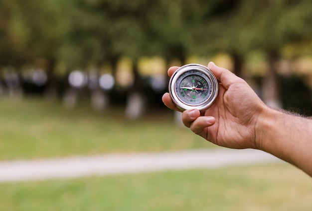 Man hand compass in nature