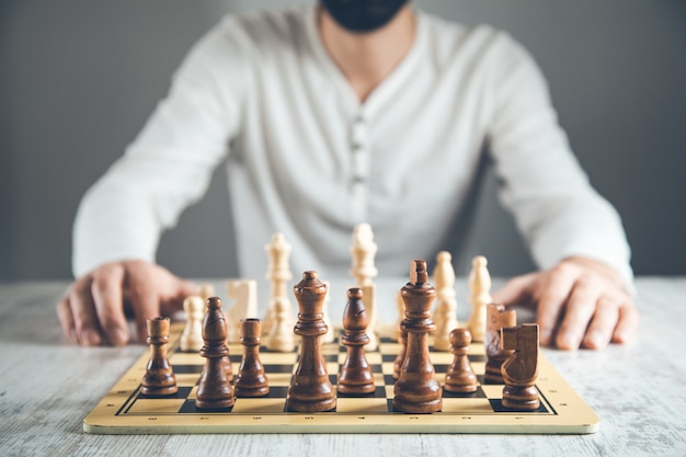 Man hand holding chess on board