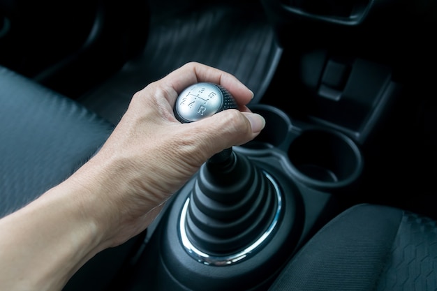 Man hand holding manual transmission 