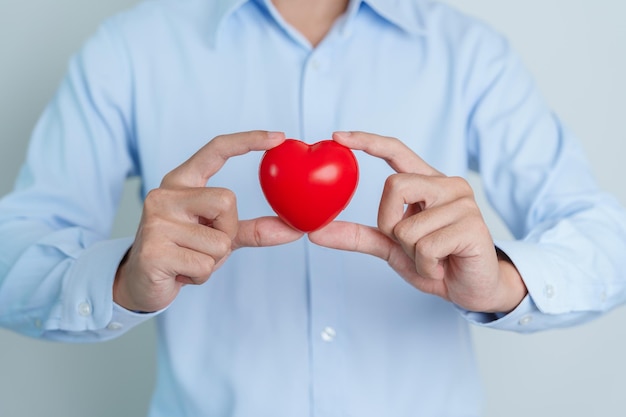 Man hand holding red heart shape love donor world heart day world health day and Insurance concepts