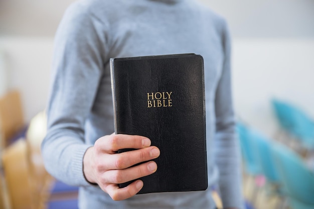 Man hand Holy Bible