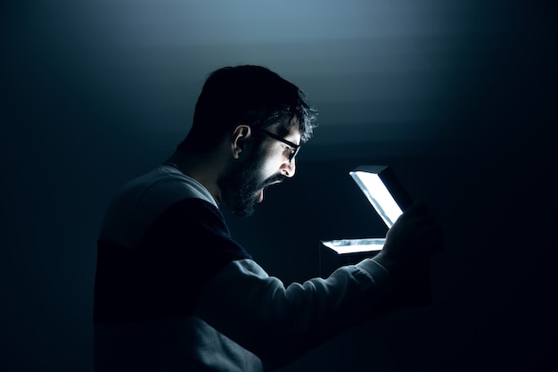 Man hand light box on dark background