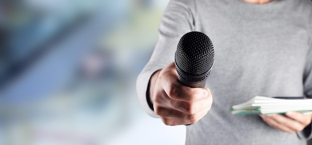 Man hand microphone and notepad