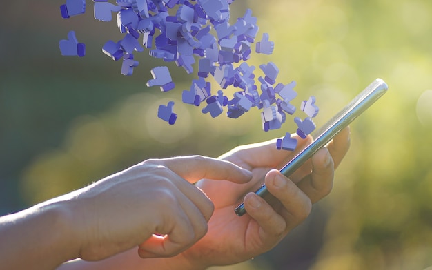 Man Hand Using Smartphone with Like Icon Notification Flying 