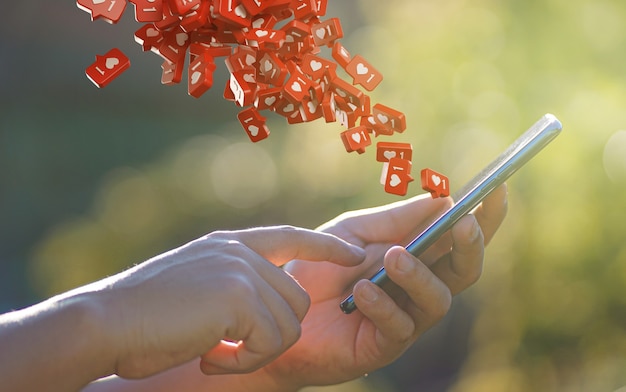 Man Hand Using Smartphone with Love Icon Notification Flying 